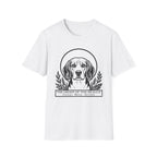 Holy Orders | Beagle T-Shirt flat lay on navy shirt featuring a stained glass style illustration of a Beagle depicted as a holy figure with a golden halo and the text 'Holy Orders.'