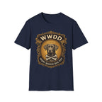 What Would Dog Do Chocolate Lab T-Shirt flat lay on navy, featuring an ornate gold WWDD badge with a halo-wearing chocolate Labrador and crossbones and the text 'What Would Dog Do?'