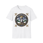 Believe in the Power of Dog Bernese T-Shirt in white, flat lay view showing a circular badge graphic with a halo-wearing Bernese Mountain Dog set against a mountain and forest landscape, with crossed bones and the words 'Loyalty Warmth Love'.