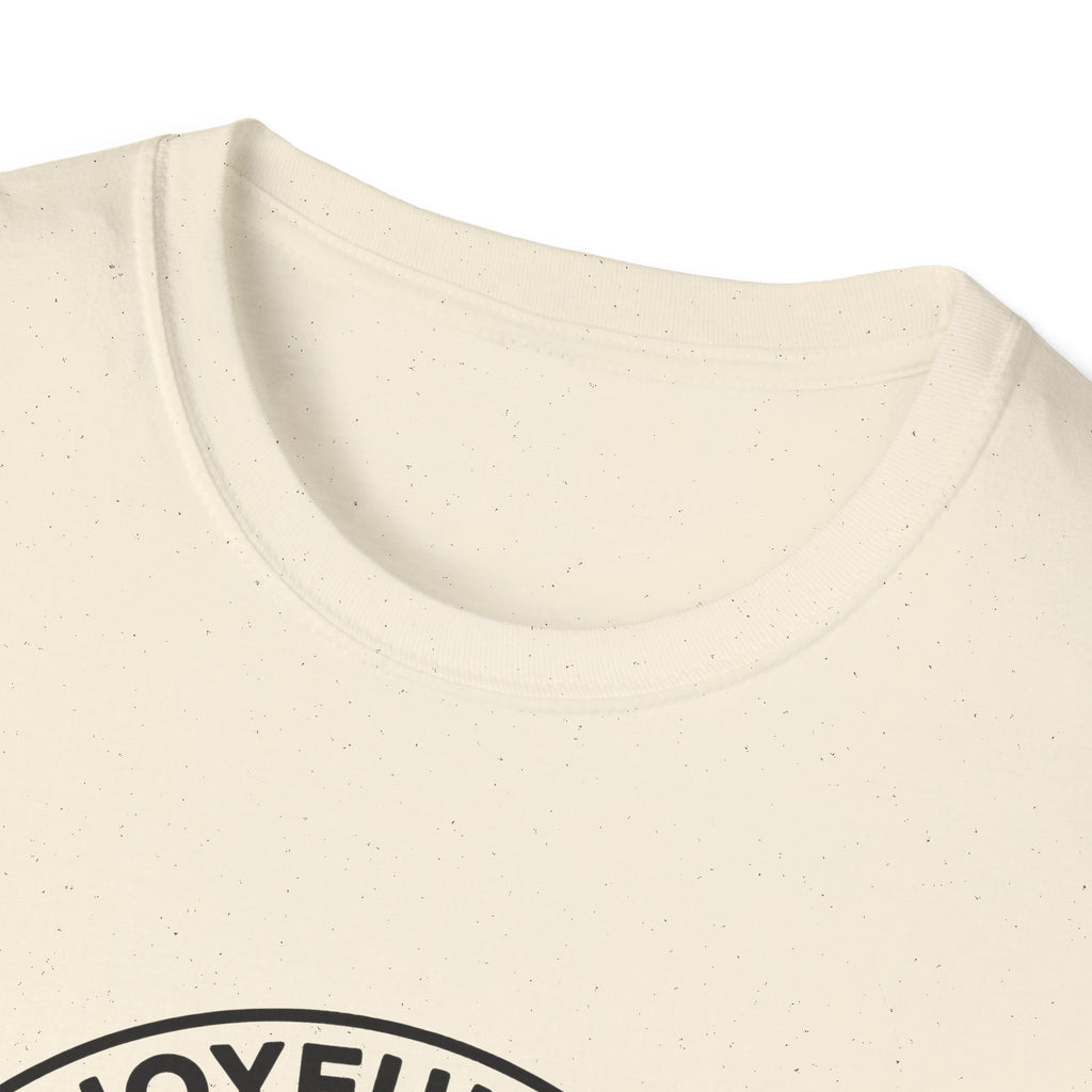 The Joyful Sound of Barking T-shirt close-up detail shot on a natural tan shirt, showing the top of the circular badge graphic with 'The Joyful Sound' lettering at the neckline.