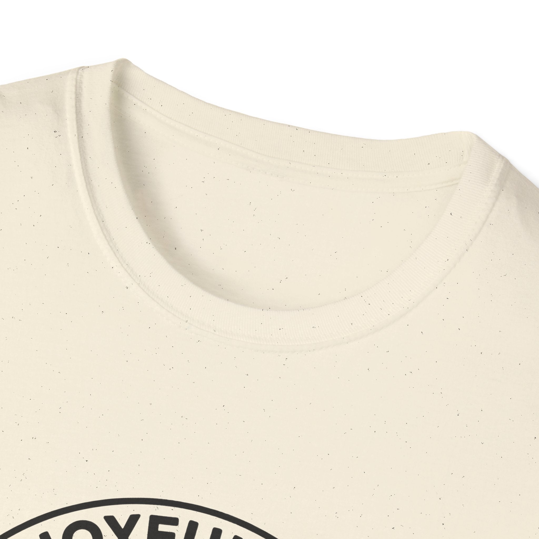 The Joyful Sound of Barking T-shirt close-up detail shot on a natural tan shirt, showing the top of the circular badge graphic with 'The Joyful Sound' lettering at the neckline.
