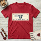 In Dog We Trust Bill T-Shirt flat lay in Cherry Red, featuring a vintage dollar-bill design with a haloed mixed-breed Dog at center, a Betsy Ross flag in the background, and bold currency-style "In Dog We Trust" typography.