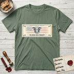 In Dog We Trust Bill T-Shirt flat lay in Military Green, featuring a vintage dollar-bill design with a haloed mixed-breed Dog at center, a Betsy Ross flag in the background, and bold currency-style "In Dog We Trust" typography.