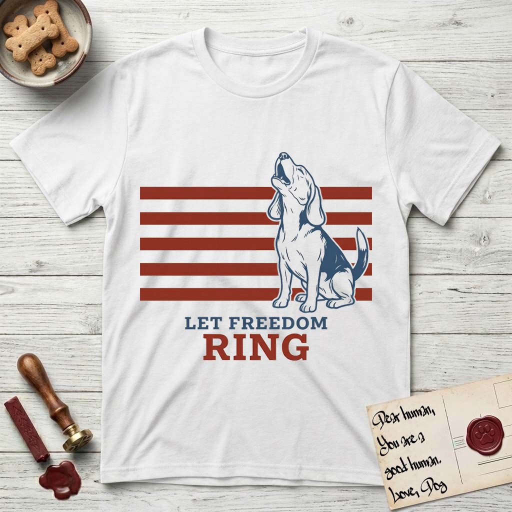 Let Freedom Ring T-Shirt flat lay in White, featuring a faded vintage-Americana line-art Beagle sitting and baying with her head thrown back in front of red flag stripes, above “Let Freedom Ring” lettering.