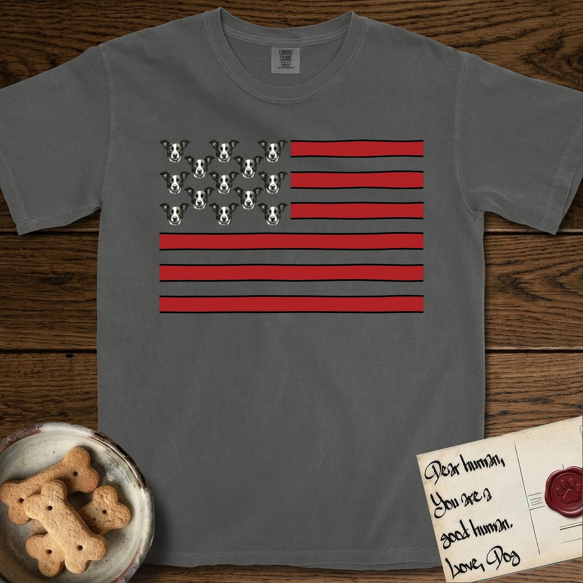 Lobo Head Flag T-Shirt flat lay in Pepper, featuring an American flag with thirteen repeated black-and-white photos of a Pitbull-and-cattle-dog-mix Dog head in place of the stars and dusty red stripes.