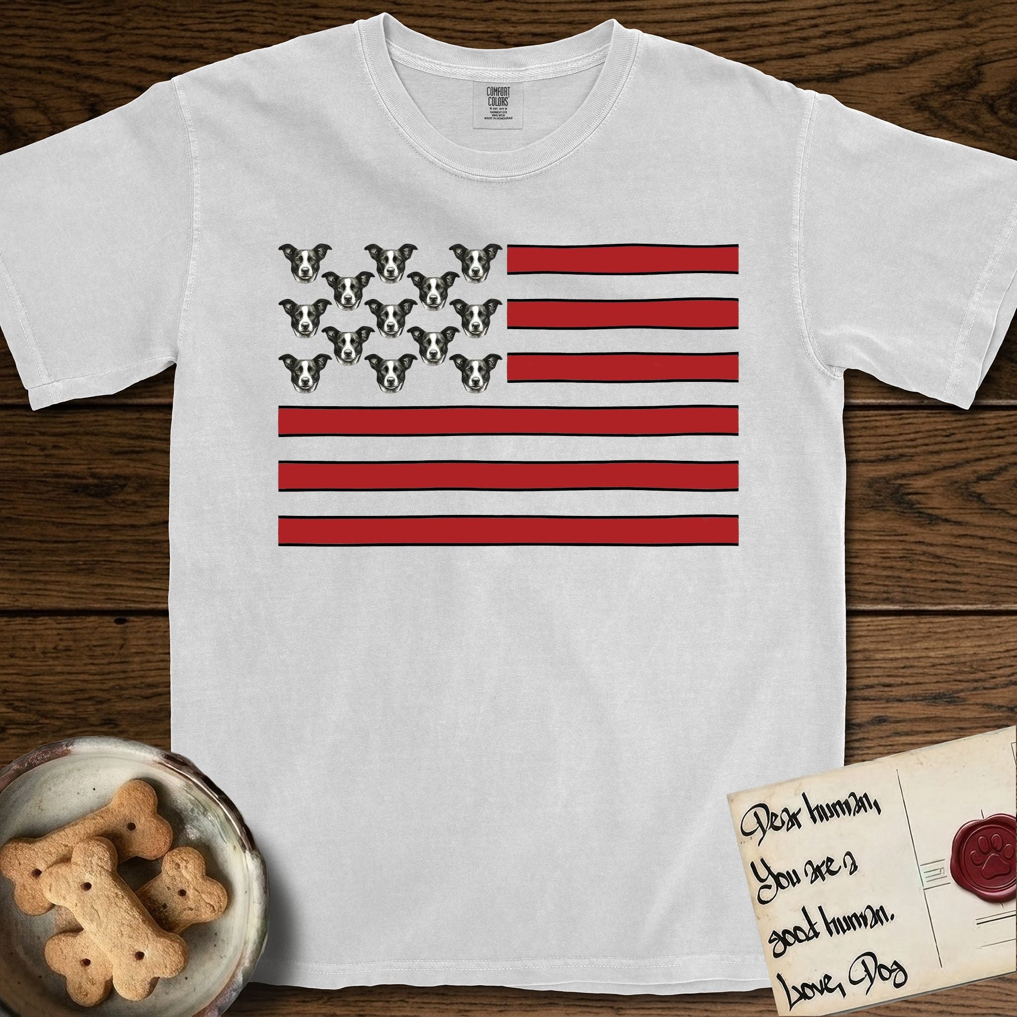 Lobo Head Flag T-Shirt flat lay in White, featuring an American flag with thirteen repeated black-and-white photos of a Pitbull-and-cattle-dog-mix Dog head in place of the stars and dusty red stripes.