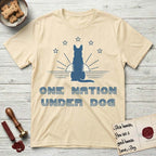 One Nation Under Dog T-Shirt flat lay in Natural, featuring a minimalist design with a Dog silhouette over a radiating sunburst, five stars, and bold "One Nation Under Dog" typography.