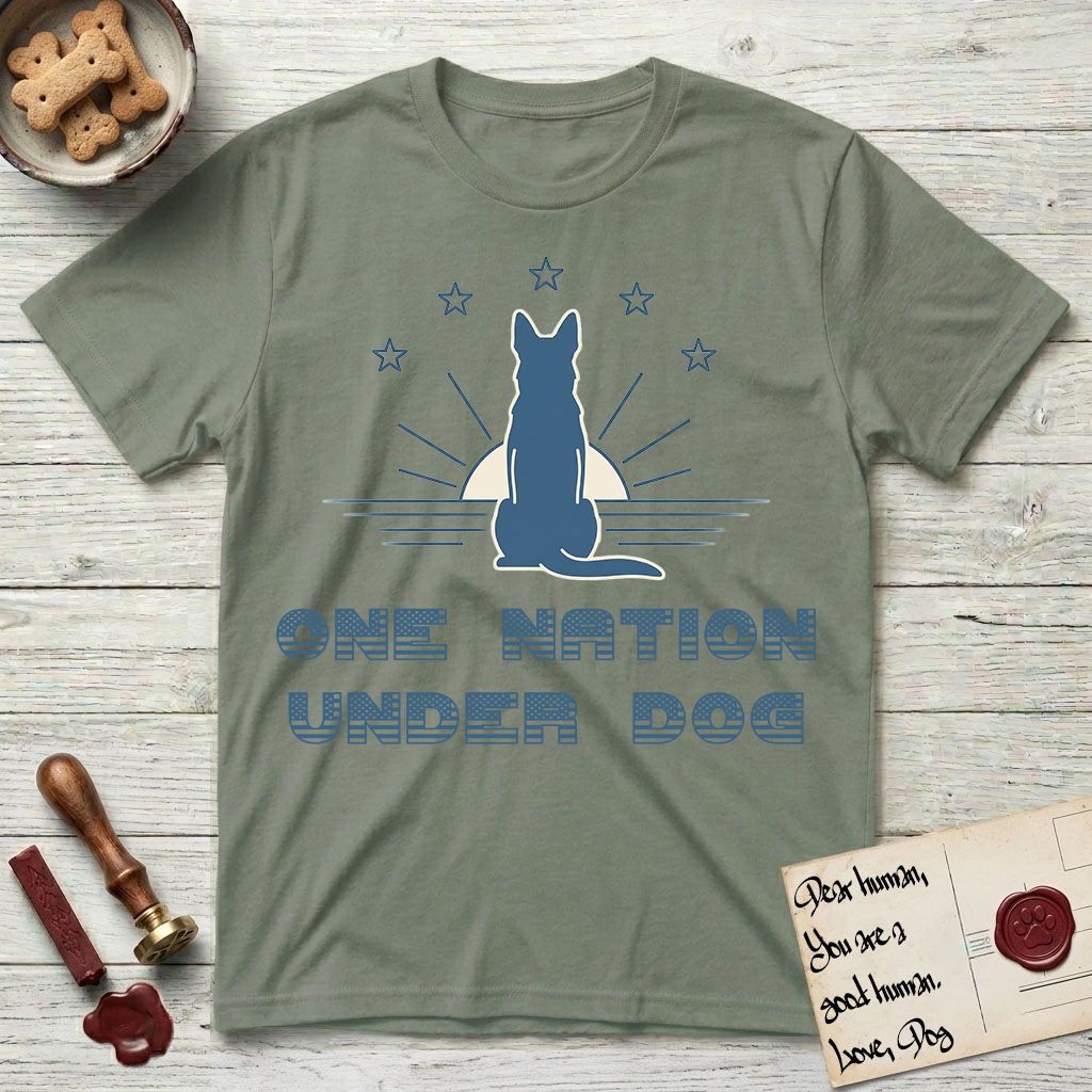 One Nation Under Dog T-Shirt flat lay in Sage, featuring a minimalist design with a Dog silhouette over a radiating sunburst, five stars, and bold "One Nation Under Dog" typography.