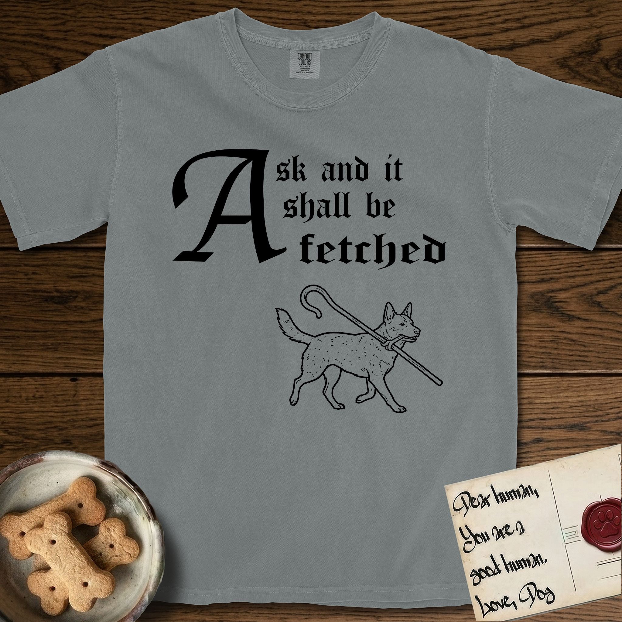 Ask and It Shall Be Fetched Australian Cattle Dog T-Shirt flat lay in Granite, featuring a sparse pen-and-ink illustration of an Australian Cattle Dog at a proud trot carrying a shepherd's crook.