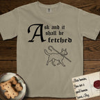 Ask and It Shall Be Fetched Australian Cattle Dog T-Shirt flat lay in Khaki, featuring a sparse pen-and-ink illustration of an Australian Cattle Dog at a proud trot carrying a shepherd's crook.