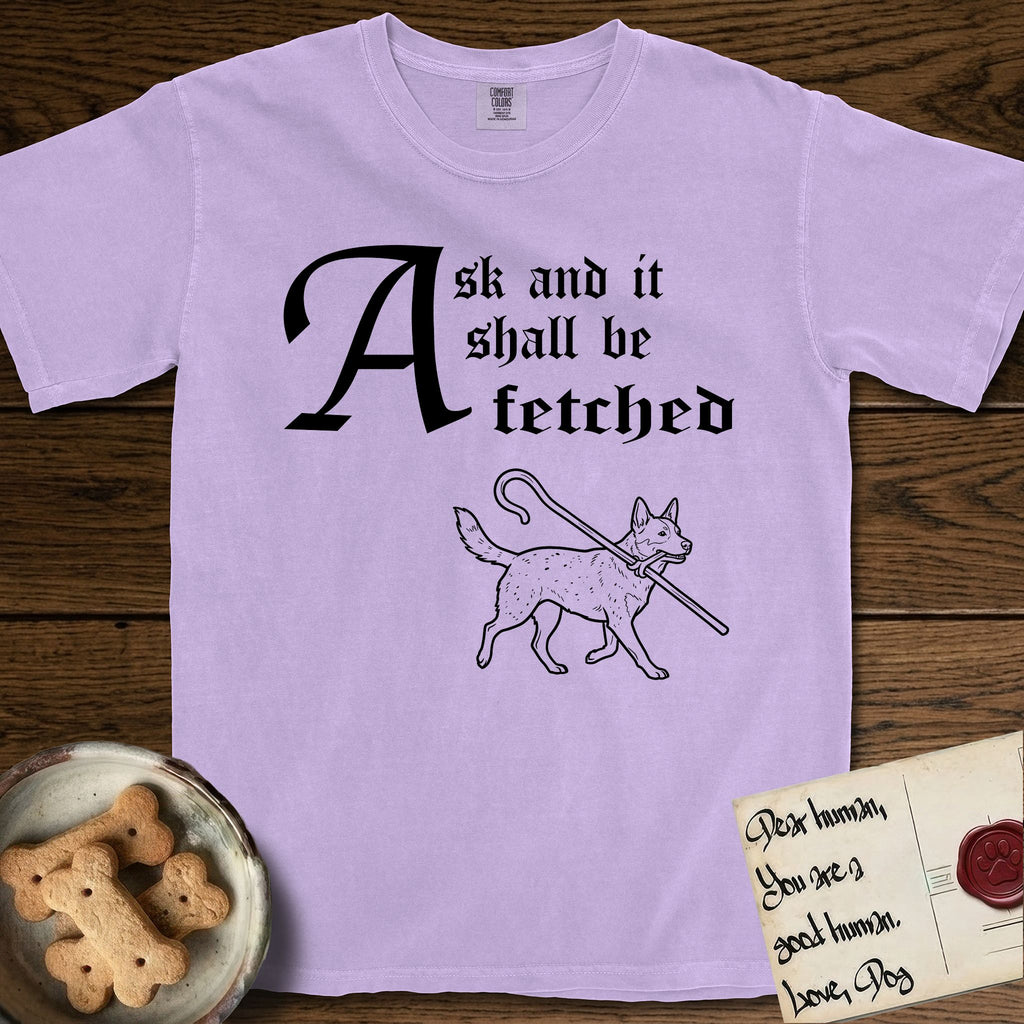 Ask and It Shall Be Fetched Australian Cattle Dog T-Shirt flat lay in Orchid, featuring a sparse pen-and-ink illustration of an Australian Cattle Dog at a proud trot carrying a shepherd's crook.