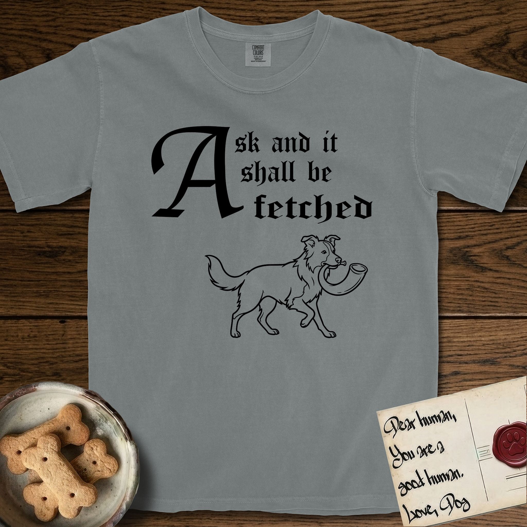 Ask and It Shall Be Fetched Border Collie T-Shirt flat lay in Granite, featuring a sparse pen-and-ink illustration of a Border Collie at a proud trot carrying a shofar.