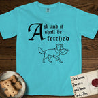 Ask and It Shall Be Fetched Border Collie T-Shirt flat lay in Lagoon Blue, featuring a sparse pen-and-ink illustration of a Border Collie at a proud trot carrying a shofar.