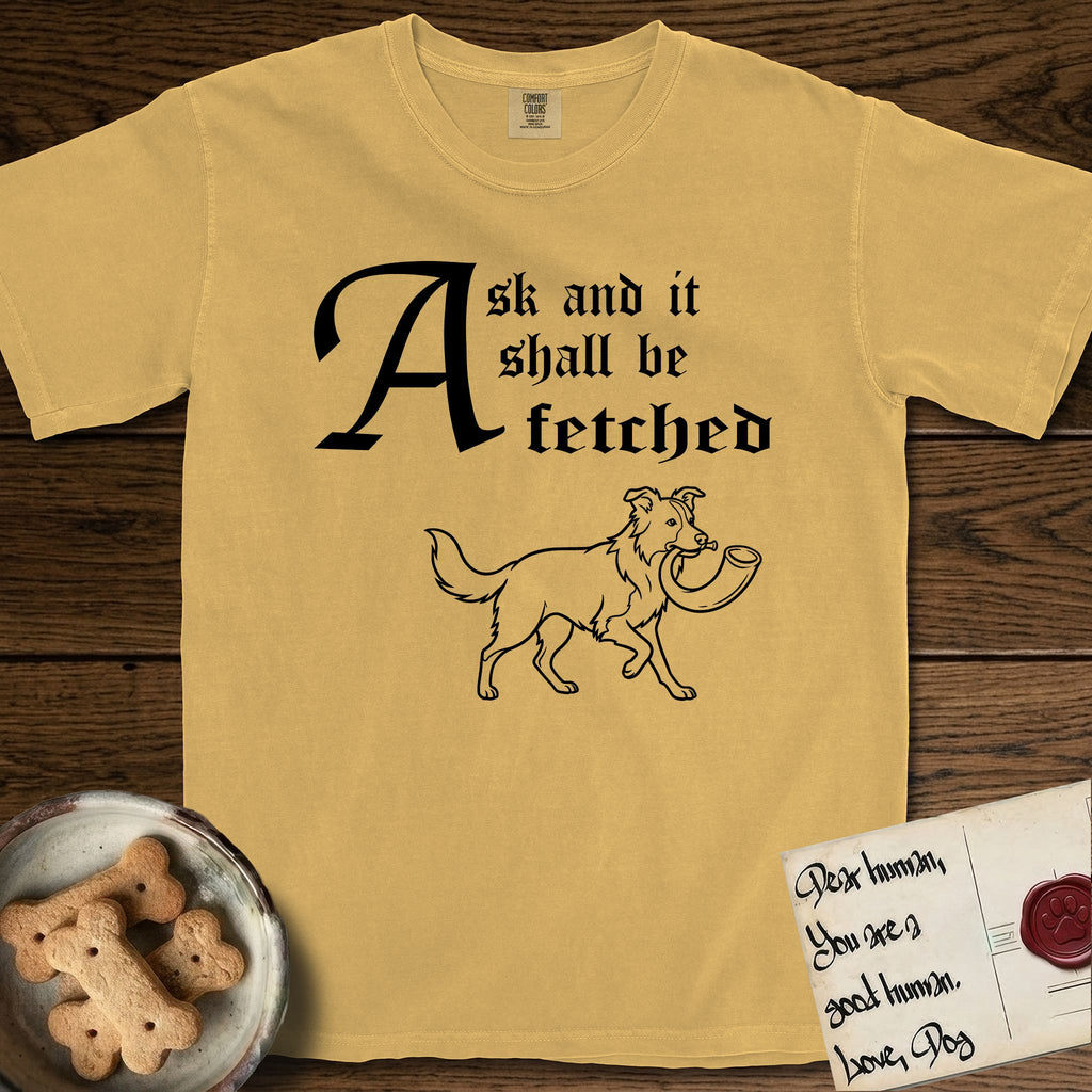 Ask and It Shall Be Fetched Border Collie T-Shirt flat lay in Mustard, featuring a sparse pen-and-ink illustration of a Border Collie at a proud trot carrying a shofar.