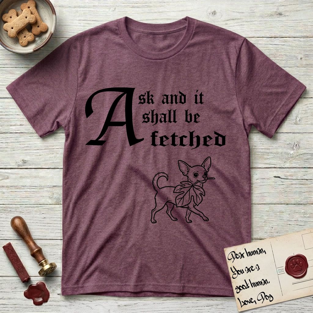 Ask and It Shall Be Fetched Chihuahua T-Shirt flat lay in Heather Maroon, featuring a sparse pen-and-ink illustration of a Chihuahua at a proud trot carrying an oversized fig leaf.