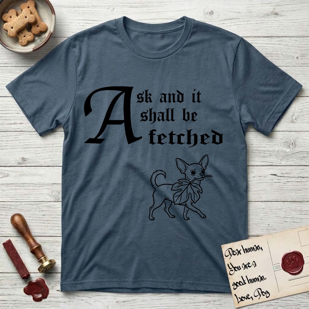 Ask and It Shall Be Fetched Chihuahua T-Shirt flat lay in Indigo Blue, featuring a sparse pen-and-ink illustration of a Chihuahua at a proud trot carrying an oversized fig leaf.