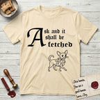 Ask and It Shall Be Fetched Chihuahua T-Shirt flat lay in Natural, featuring a sparse pen-and-ink illustration of a Chihuahua at a proud trot carrying an oversized fig leaf.