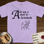 Ask and It Shall Be Fetched Chihuahua T-Shirt flat lay in Orchid, featuring a sparse pen-and-ink illustration of a Chihuahua at a proud trot carrying an oversized fig leaf.