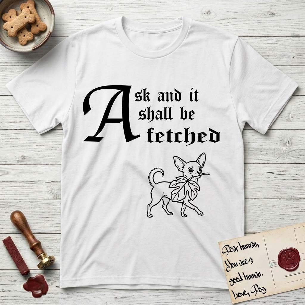 Ask and It Shall Be Fetched Chihuahua T-Shirt flat lay in White, featuring a sparse pen-and-ink illustration of a Chihuahua at a proud trot carrying an oversized fig leaf.