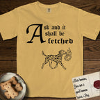 Ask and It Shall Be Fetched Dalmatian T-Shirt flat lay in Mustard, featuring a sparse pen-and-ink illustration of a Dalmatian at a proud trot carrying a small burning bush.