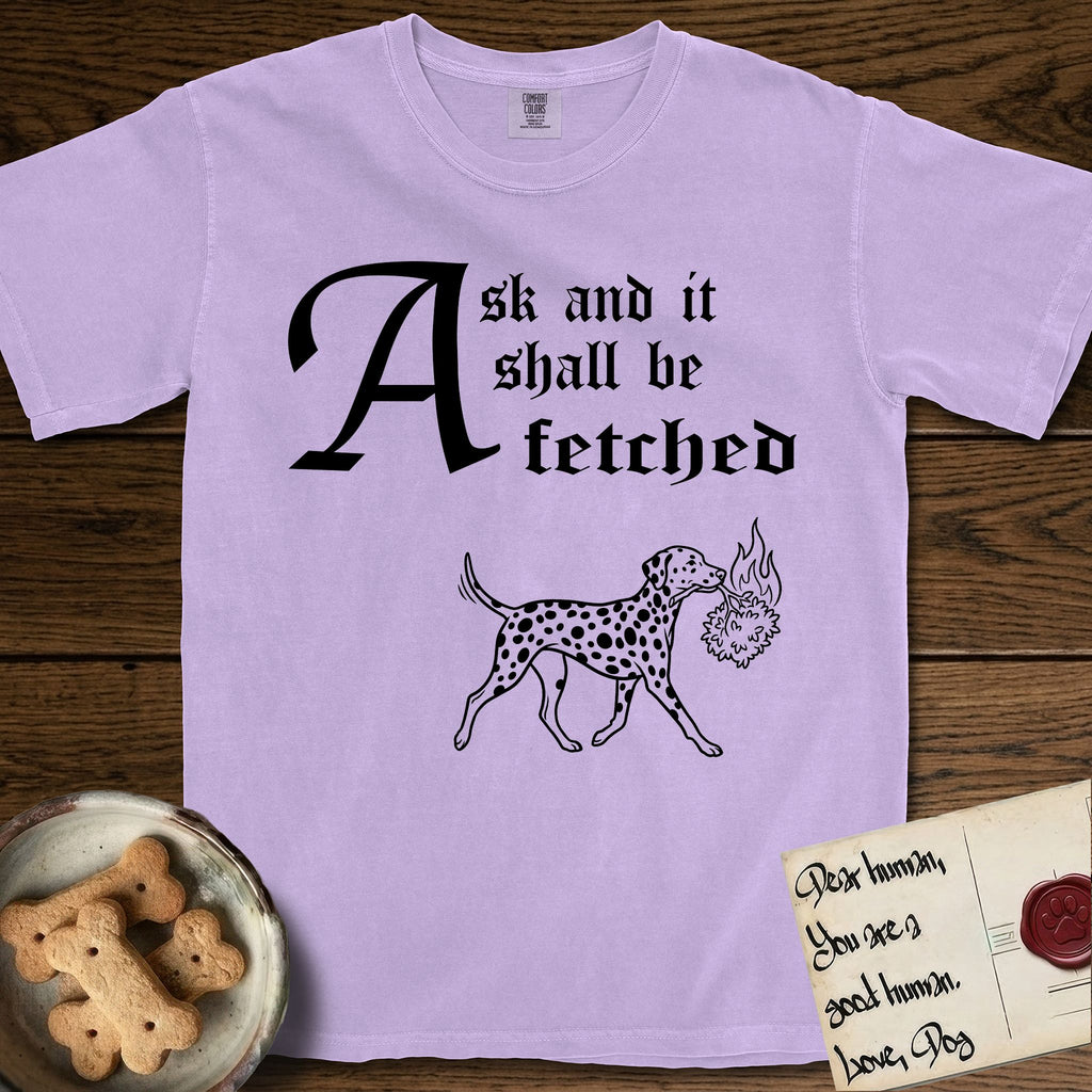 Ask and It Shall Be Fetched Dalmatian T-Shirt flat lay in Orchid, featuring a sparse pen-and-ink illustration of a Dalmatian at a proud trot carrying a small burning bush.