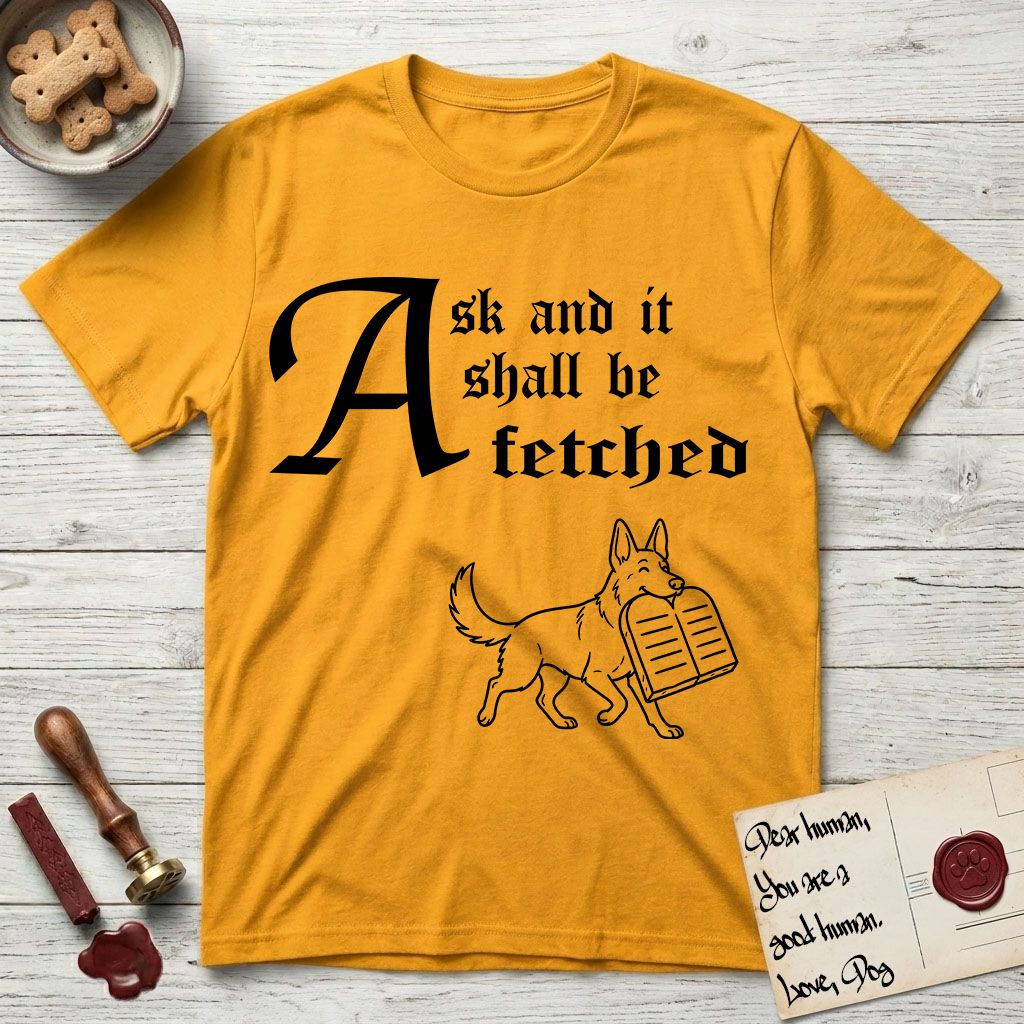 Ask and It Shall Be Fetched German Shepherd T-Shirt flat lay in Gold, featuring a sparse pen-and-ink illustration of a German Shepherd at a proud trot carrying a pair of stone tablets.