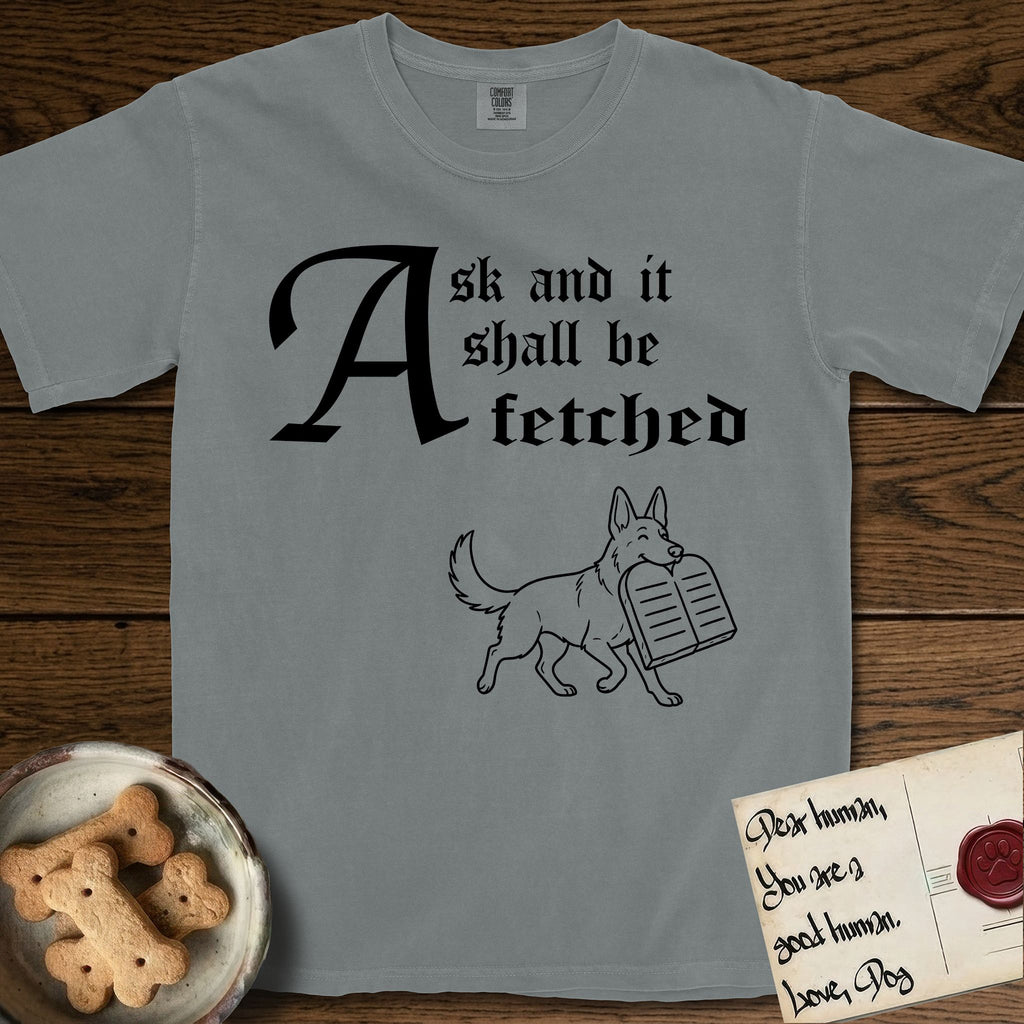 Ask and It Shall Be Fetched German Shepherd T-Shirt flat lay in Granite, featuring a sparse pen-and-ink illustration of a German Shepherd at a proud trot carrying a pair of stone tablets.
