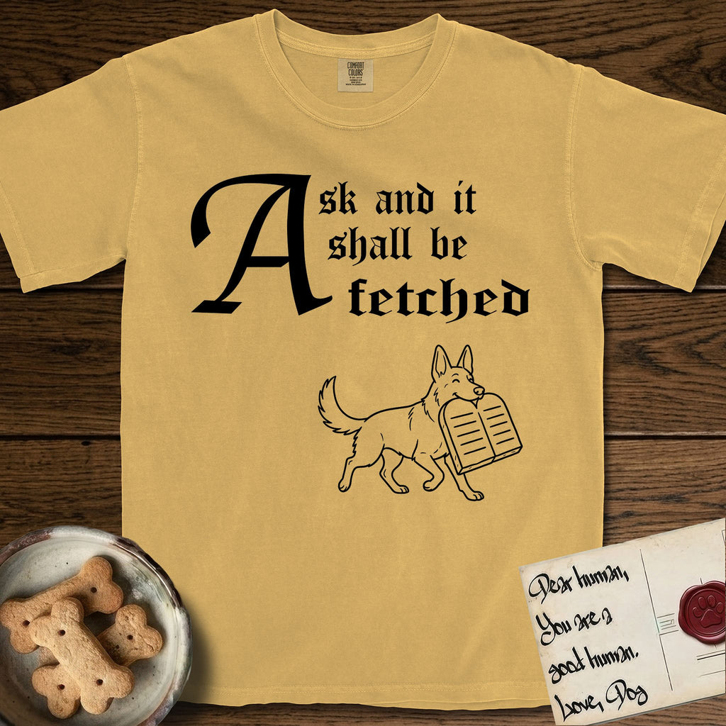Ask and It Shall Be Fetched German Shepherd T-Shirt flat lay in Mustard, featuring a sparse pen-and-ink illustration of a German Shepherd at a proud trot carrying a pair of stone tablets.