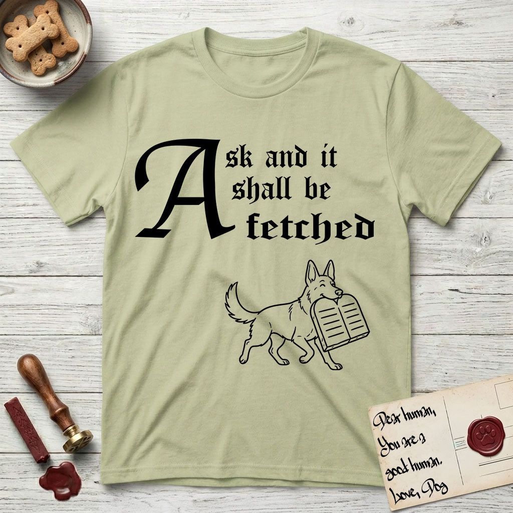 Ask and It Shall Be Fetched German Shepherd T-Shirt flat lay in Pistachio, featuring a sparse pen-and-ink illustration of a German Shepherd at a proud trot carrying a pair of stone tablets.