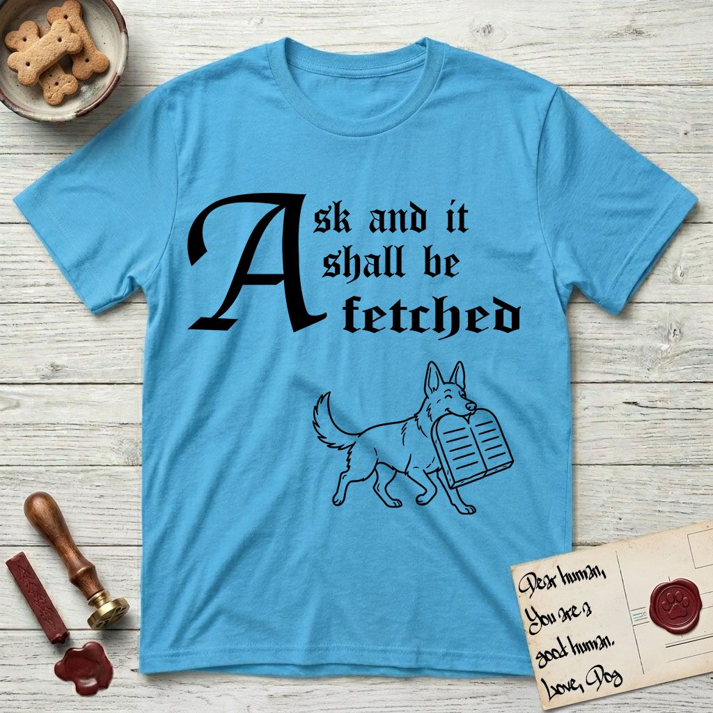 Ask and It Shall Be Fetched German Shepherd T-Shirt flat lay in Sky, featuring a sparse pen-and-ink illustration of a German Shepherd at a proud trot carrying a pair of stone tablets.