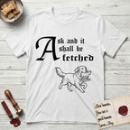 Ask and It Shall Be Fetched Golden Retriever T-Shirt flat lay in White, featuring a sparse pen-and-ink illustration of a Golden Retriever at a proud trot carrying a golden calf idol on a plinth.
