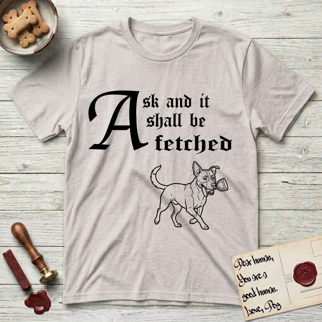Ask and It Shall Be Fetched Lobo T-Shirt flat lay in Ice Grey, featuring a sparse pen-and-ink illustration of Lobo, a black-and-white Australian Cattle Dog and Pitbull mix, at a proud trot carrying a chalice.