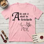 Ask and It Shall Be Fetched Lobo T-Shirt flat lay in Light Pink, featuring a sparse pen-and-ink illustration of Lobo, a black-and-white Australian Cattle Dog and Pitbull mix, at a proud trot carrying a chalice.