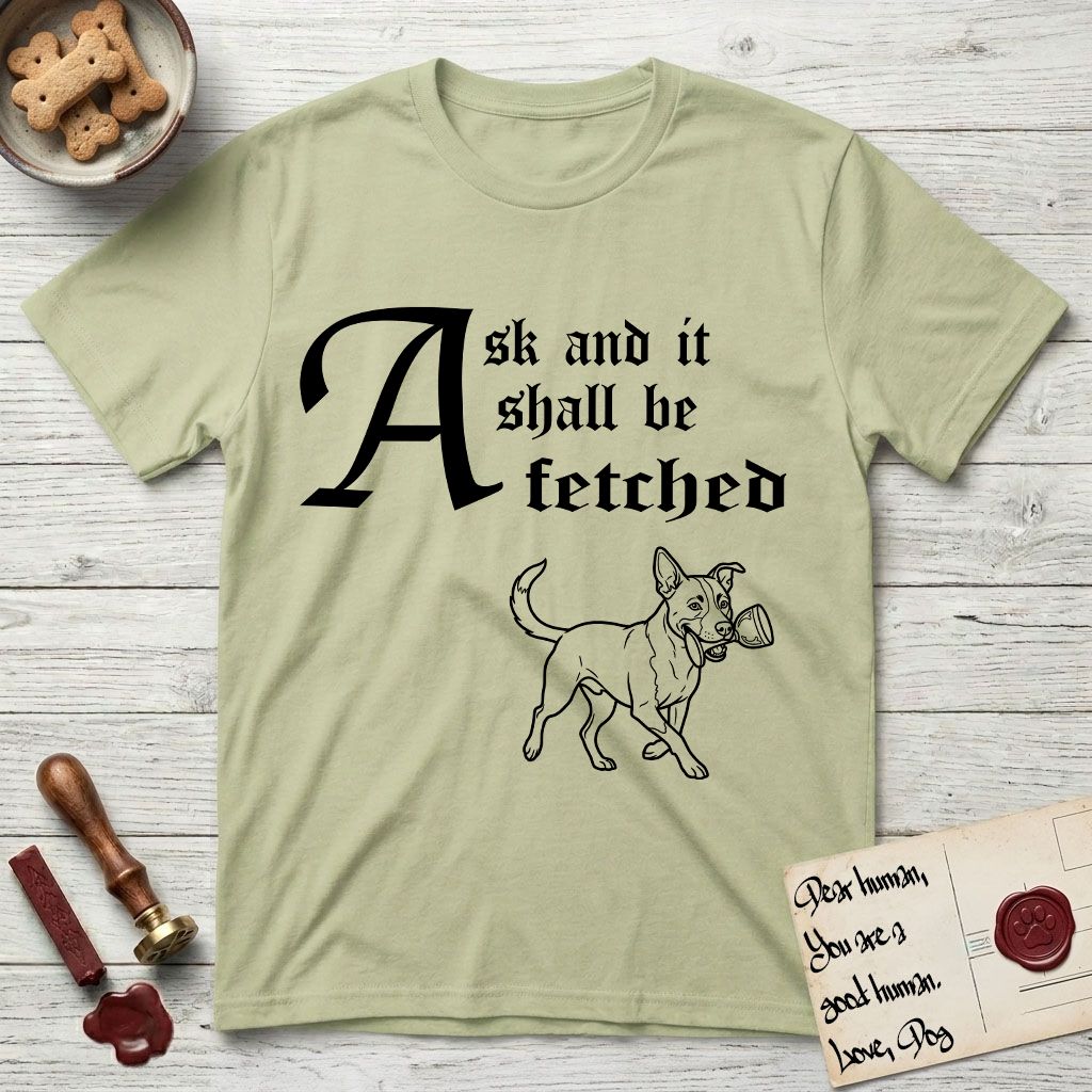 Ask and It Shall Be Fetched Lobo T-Shirt flat lay in Pistachio, featuring a sparse pen-and-ink illustration of Lobo, a black-and-white Australian Cattle Dog and Pitbull mix, at a proud trot carrying a chalice.