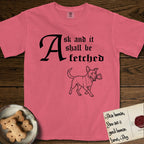 Ask and It Shall Be Fetched Lobo T-Shirt flat lay in Watermelon, featuring a sparse pen-and-ink illustration of Lobo, a black-and-white Australian Cattle Dog and Pitbull mix, at a proud trot carrying a chalice.