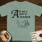 Ask and It Shall Be Fetched Newfoundland T-Shirt flat lay in Bay, featuring a sparse pen-and-ink illustration of a Newfoundland at a proud trot carrying loaves and fishes.