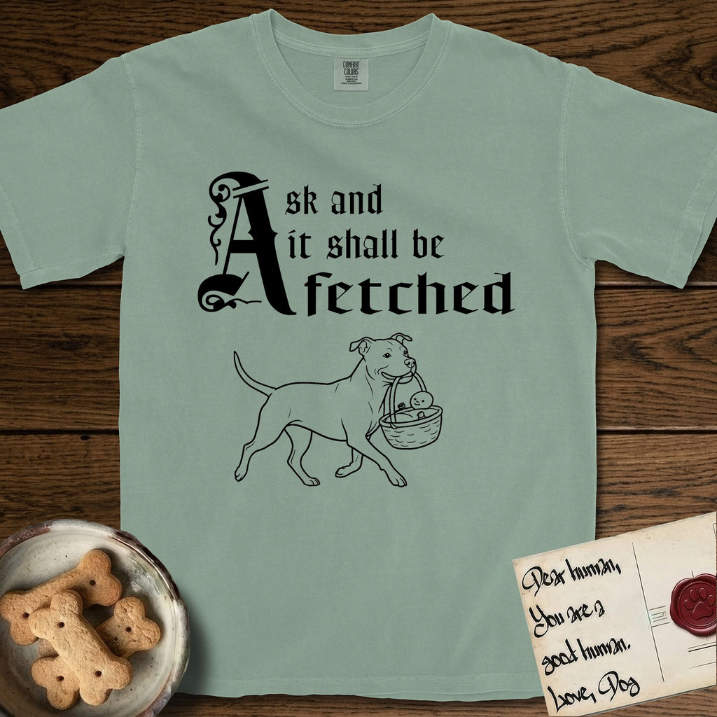 Ask and It Shall Be Fetched Pitbull T-Shirt flat lay in Bay, featuring a sparse pen-and-ink illustration of a Pitbull at a proud trot carrying a baby in a reed basket.