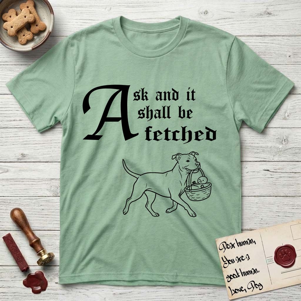 Ask and It Shall Be Fetched Pitbull T-Shirt flat lay in Mint Green, featuring a sparse pen-and-ink illustration of a Pitbull at a proud trot carrying a baby in a reed basket.