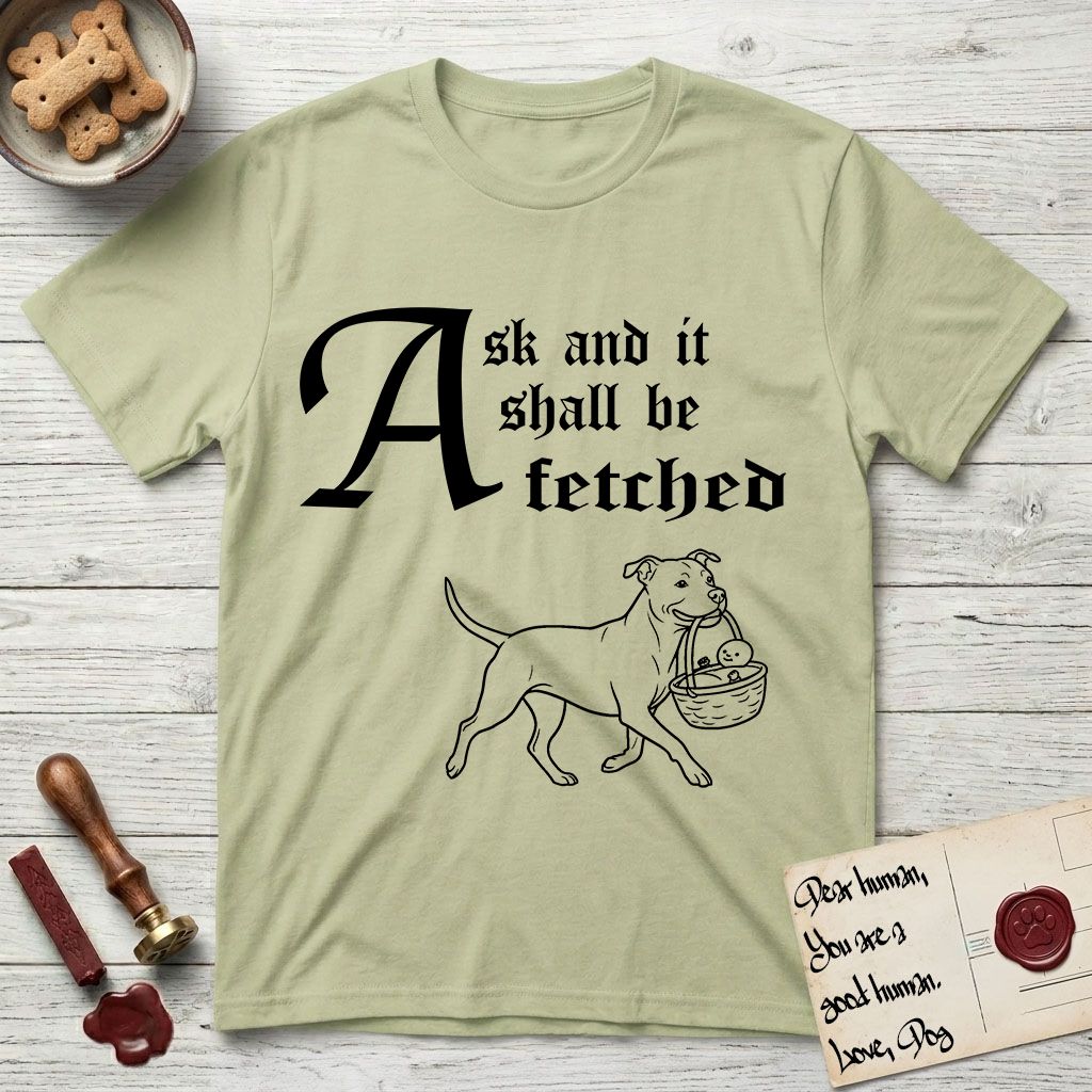 Ask and It Shall Be Fetched Pitbull T-Shirt flat lay in Pistachio, featuring a sparse pen-and-ink illustration of a Pitbull at a proud trot carrying a baby in a reed basket.