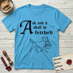 Ask and It Shall Be Fetched Pitbull T-Shirt flat lay in Sky, featuring a sparse pen-and-ink illustration of a Pitbull at a proud trot carrying a baby in a reed basket.
