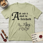 Ask and It Shall Be Fetched Rescue Mutt T-Shirt flat lay in Pistachio, featuring a sparse pen-and-ink illustration of a rescue mutt at a proud trot carrying a very surprised ram.