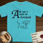 Ask and It Shall Be Fetched Spaniel T-Shirt flat lay in Lagoon Blue, featuring a sparse pen-and-ink illustration of a Spaniel at a proud trot carrying a dove with an olive branch.