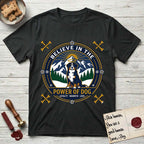 Believe in the Power of Dog Bernese Mountain Dog T-Shirt flat lay in Black, featuring a circular national-park-style badge with a haloed Bernese Mountain Dog, a mountain scene, a rope border, and the words Loyalty, Warmth, Love.
