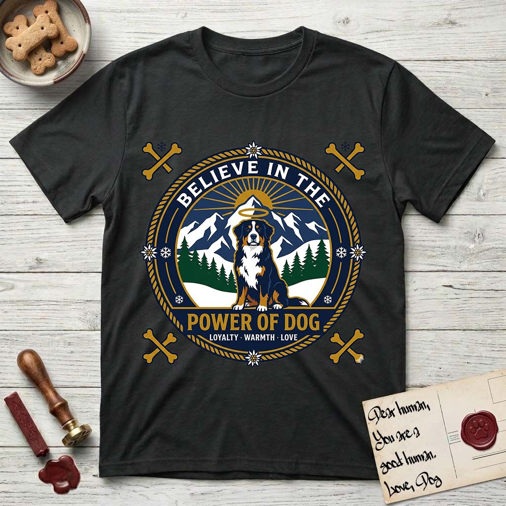 Believe in the Power of Dog Bernese Mountain Dog T-Shirt flat lay in Black, featuring a circular national-park-style badge with a haloed Bernese Mountain Dog, a mountain scene, a rope border, and the words Loyalty, Warmth, Love.