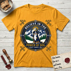 Believe in the Power of Dog Bernese Mountain Dog T-Shirt flat lay in Gold, featuring a circular national-park-style badge with a haloed Bernese Mountain Dog, a mountain scene, a rope border, and the words Loyalty, Warmth, Love.