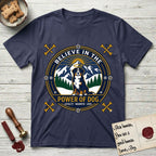 Believe in the Power of Dog Bernese Mountain Dog T-Shirt flat lay in Navy, featuring a circular national-park-style badge with a haloed Bernese Mountain Dog, a mountain scene, a rope border, and the words Loyalty, Warmth, Love.