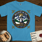 Believe in the Power of Dog Bernese Mountain Dog T-Shirt flat lay in Royal Caribe, featuring a circular national-park-style badge with a haloed Bernese Mountain Dog, a mountain scene, a rope border, and the words Loyalty, Warmth, Love.