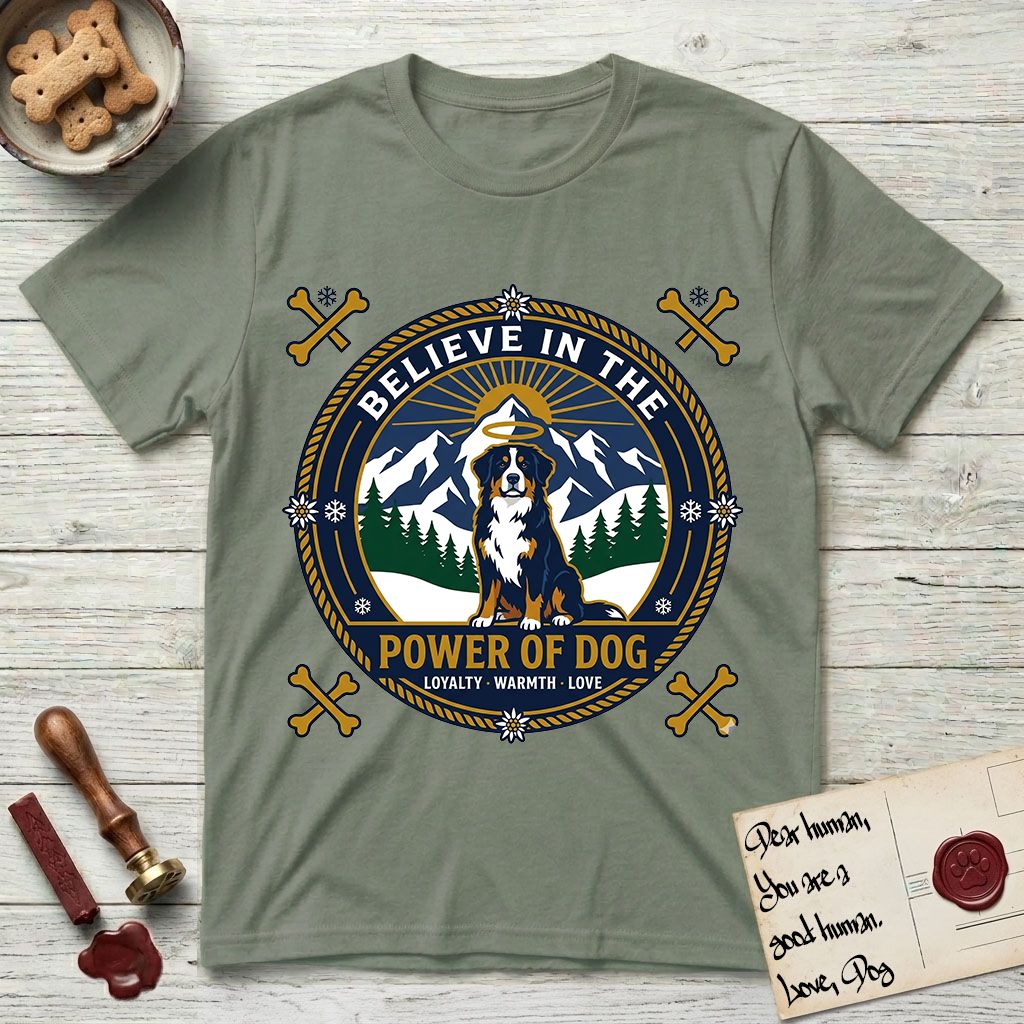 Believe in the Power of Dog Bernese Mountain Dog T-Shirt flat lay in Sage, featuring a circular national-park-style badge with a haloed Bernese Mountain Dog, a mountain scene, a rope border, and the words Loyalty, Warmth, Love.