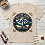 Believe in the Power of Dog Bernese Mountain Dog T-Shirt flat lay in Sand, featuring a circular national-park-style badge with a haloed Bernese Mountain Dog, a mountain scene, a rope border, and the words Loyalty, Warmth, Love.