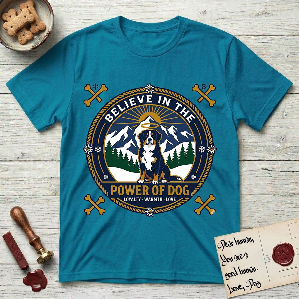 Believe in the Power of Dog Bernese Mountain Dog T-Shirt flat lay in Tropical Blue, featuring a circular national-park-style badge with a haloed Bernese Mountain Dog, a mountain scene, a rope border, and the words Loyalty, Warmth, Love.